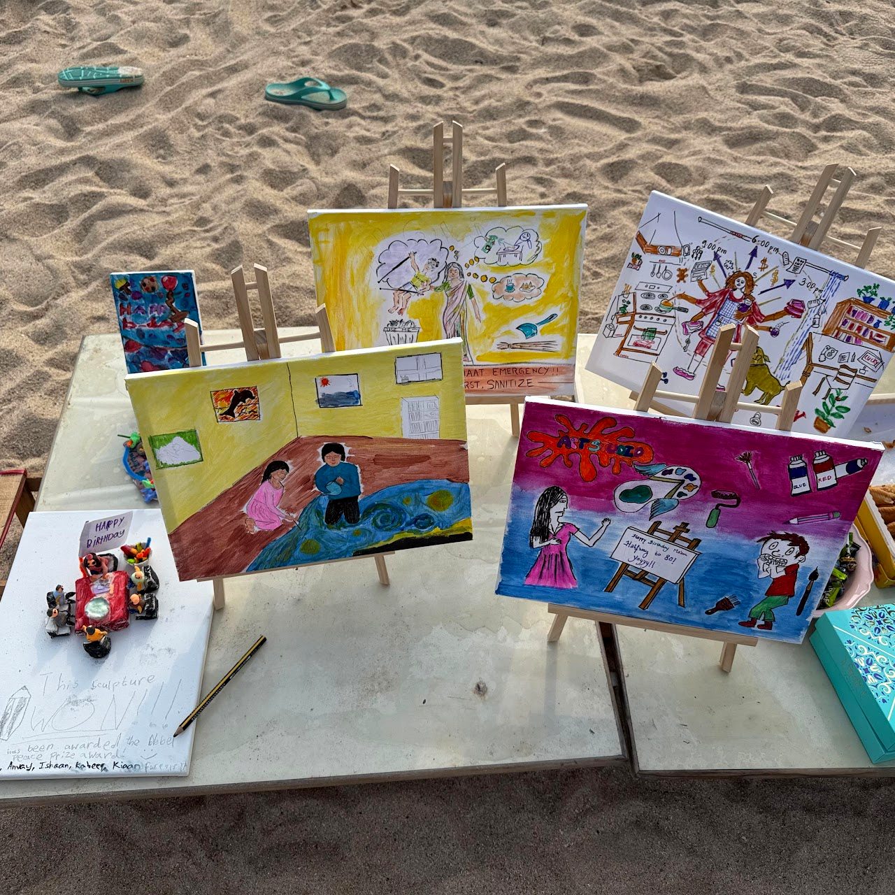 Painted boards propped on a table on the sand