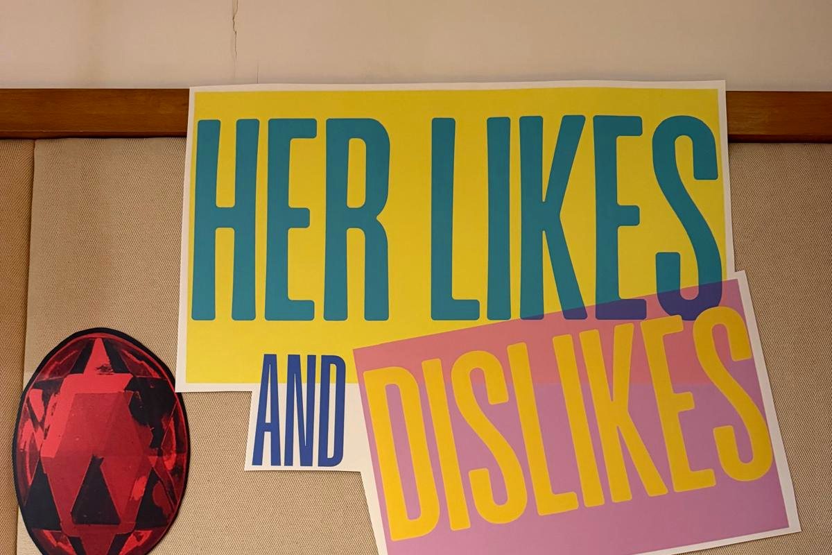 A printed banner titled Her Likes and Dislikes with the scoring rules