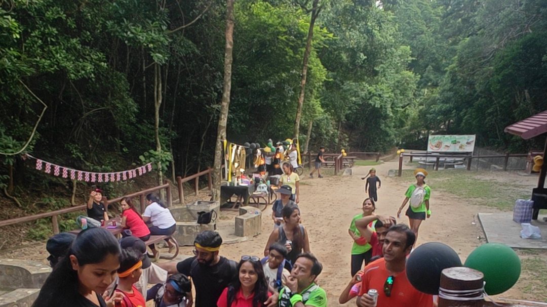 Runners in team colours setting off up a flight of trail steps