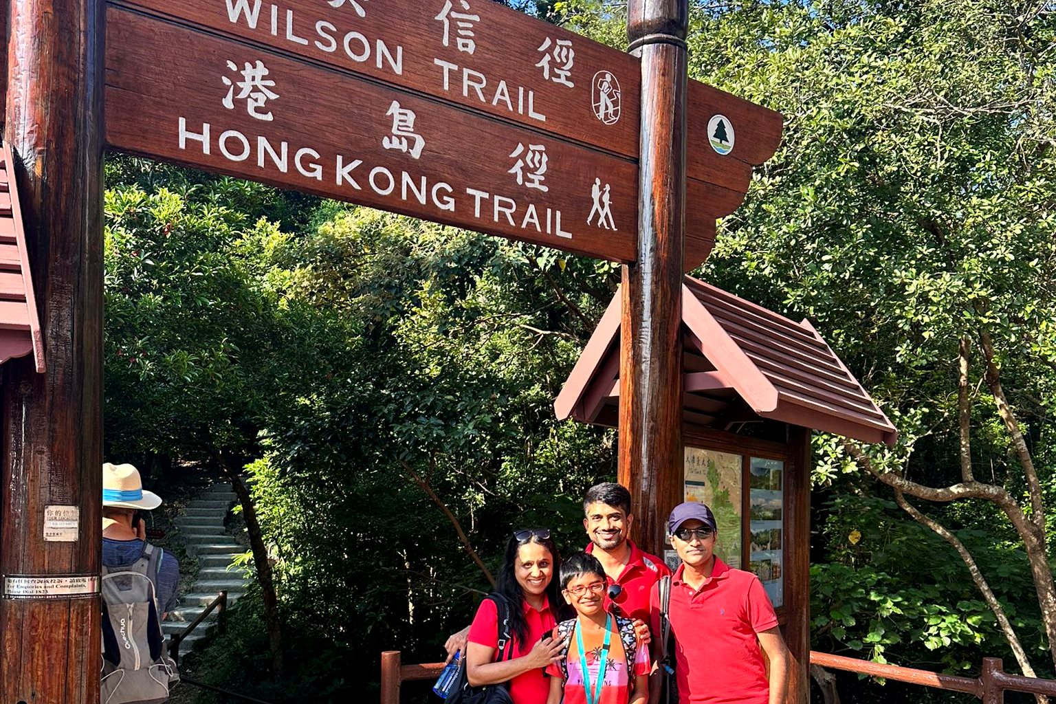 A team gathered at a country trail signpost