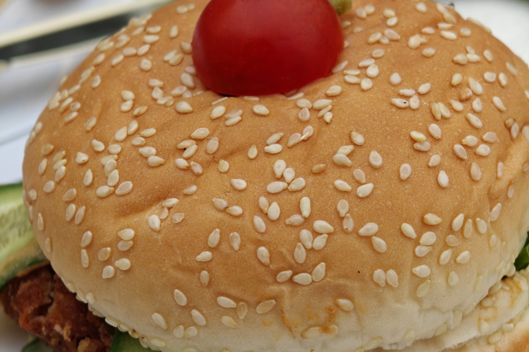 A plated burger and salad on a gold-rimmed plate